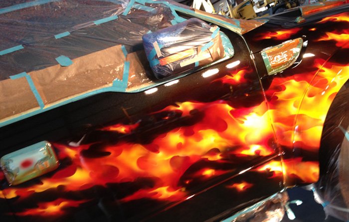 Real Fire flames on a 2013 Ford Raptor owned by Fuego Wireless.