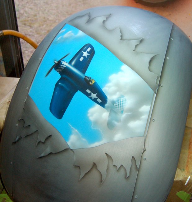  Mural of a WWII Coursair coming out of the clouds.